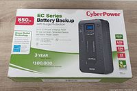 Box front showing product name, power rating 850 VA / 510 Watts, green outlet technology, and warranty information.