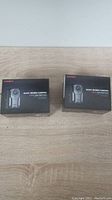 Two boxed Aolbea body cameras showing packaging and product name