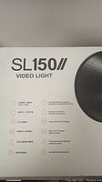 Front of retail box showing SL150II model name, video light designation and key features icons
