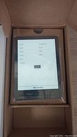 Kindle Paperwhite in original box at initial setup screen