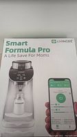 Box front showing Smart Formula Pro baby formula maker and phone app compatibility.