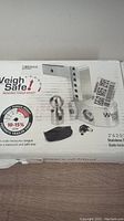 Front of product box showing the Weigh Safe truck towing scale kit with adjustable hitch extension, stainless steel balls, and carrying pouch.