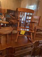 Image showing wooden doll-sized rocking chair, round stool, and two small chairs on top of a wooden surface with large mirror in background