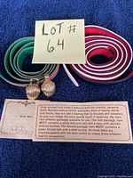 Three colorful Sarah Coventry shell belts with attached labels and notes describing the item.