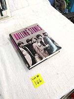 Front cover of the hardcover book 'The Rolling Stones' by Susan Hill showing the band members in black and white.