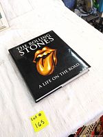 Closed view of The Rolling Stones book showing front cover with iconic tongue logo.