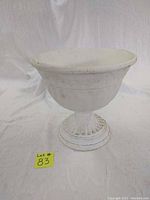 Front view of white painted cast iron plant stand showing bowl and base