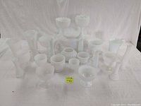 Overview of the 24 milk glass items including vases, planters, candle holders, and candy dishes all in white milk glass.