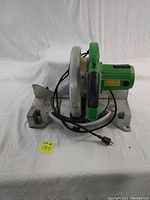 Photo of Superior Power Tools table saw from a left top angle showing green handle, metal base, and corded power plug.