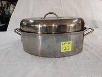 Side view of oval metal roasting pan with fitted lid