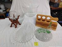 Full lot contents showing wooden camel stand with glass fish bowl, large glass lobster platter, glass bowl, Alexander Keith's beer boards, green glass decanter with glasses, lemon juicer, and marble cutting board.