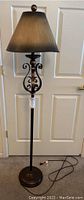 Full view of 62 inch bronze colored floor lamp showing metal base, pole, and large bronze shade.