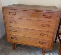 Front elevation of dresser showing four drawers with recessed handles