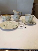 Full set showing teacup, two saucers, sugar bowl, and creamer