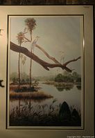 Framed wildlife print showing palm trees, water, and white birds perched on a branch