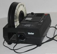 Vivitar 35mm slide projector loaded with a circular slide tray, powered and in good condition