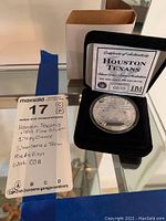 Photo showing the silver medallion in presentation box along with COA and note card.