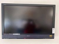 Front view of the Sony 40 inch television showing the screen, black bezel with Sony logo and attached wall mount bracket.