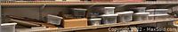 Shelf of plastic storage bins filled with various model train parts and supplies.