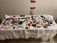 Full view of all sailboat ornaments and nautical decorations spread on a white towel over a table.