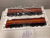 Two locomotive bodies (A unit and B unit) in foam tray, wrapped in plastic