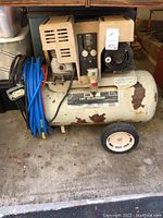 Front and side view of Sears 2 HP air compressor with tank and motor housing showing rust and paint chipping.