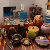 Full lot overview showing all items including Asian figurines, sterling silver items, glassware, and documents