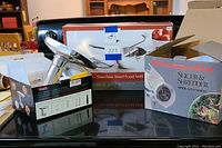 Photo of stainless steel food mill with attachments and original box and GTING food grinder attachment.