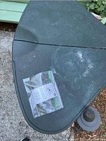Close-up of top of Rubbermaid outdoor storage cabinet showing stains and scratches.