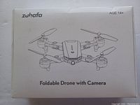 White box with Zuhafa branding and illustration of foldable drone with camera.