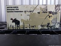 Side of the boxed hunting camera showing waterproof rating and temperature operating range