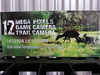 Photo of product box with 12 Mega Pixels Game Camera Trail Camera text and model numbers Ltl-5210A and Ltl-5210MM. Shows operational temperature range -22 to 158 F.