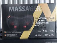 Box front showing 'Massager' text and product image with glowing red nodes representing heat and massage points.