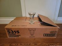 Box containing 24 Libbey sundae glasses with one glass displayed on top; box marked with Libbey, model 5315, capacity 6 1/4 oz, 2 dozen glasses.