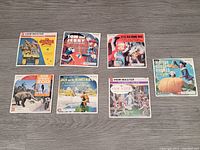 Seven complete View-Master packets laid out on the table, with colorful illustrated sleeves visible.