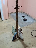 Full view of the old folk art child's wooden coat rack with visible painted animal figures on the base