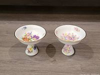 Wide shot of the two Bayreuth Gloria porcelain compotes showing floral patterns and gold trim