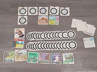 View-Master story reels and loose slides laid out on a table, showing many circular reels and slide cards with diverse images and titles.