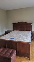 Full view of bed frame assembled with mattress and box spring.