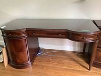 Front view of the desk showing three drawers and overall design