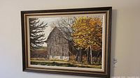 Full view of the framed painting showing the barn and autumn trees
