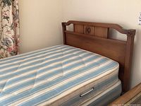 Full side view of wood headboard and mattress