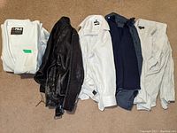 Lot laid out on floor: 2 BJJ Gis, leather jacket, 3 dress shirts (white and navy)