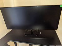 Front view of 34-inch LG UltraWide monitor on desk with power cord visible