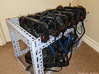 Overall open-frame rig showing six GPUs and power supply