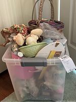 Full plastic tote packed with Easter decorations including baskets, figurines, and ornaments visible.