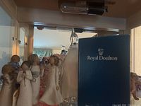 Ceramic angel figurines with Royal Doulton box visible behind