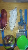 Overview of glass balls and hanging glass decorations on a wooden surface.