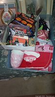 Photo showing assorted holiday decorations including Halloween cookie cutters, various themed napkins, paper plates, and cups for Halloween, fall, and Valentine's Day.