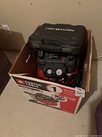 Compressor and box in cardboard container